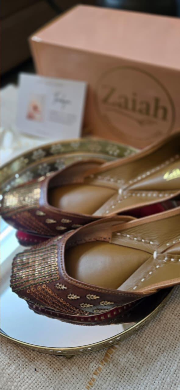 Pair of bronzebloom jutti with a 'Zaiah' box in the background