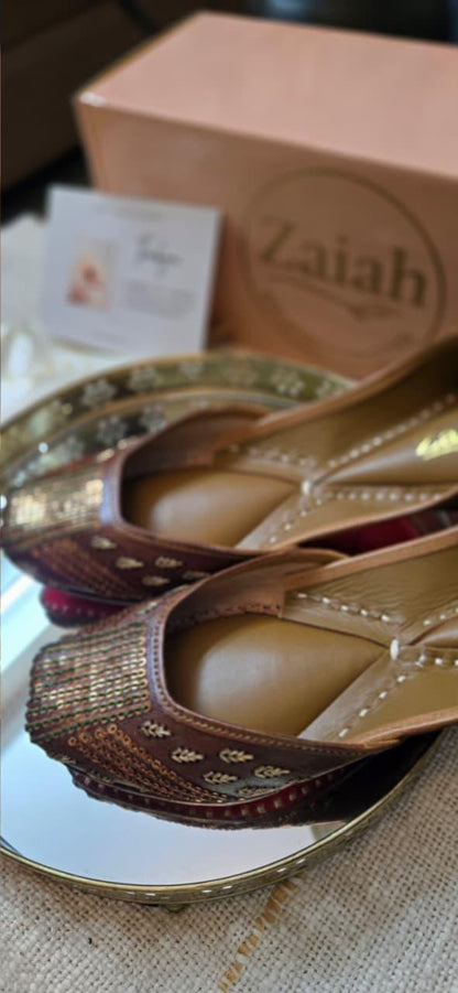 Pair of bronzebloom jutti with a 'Zaiah' box in the background