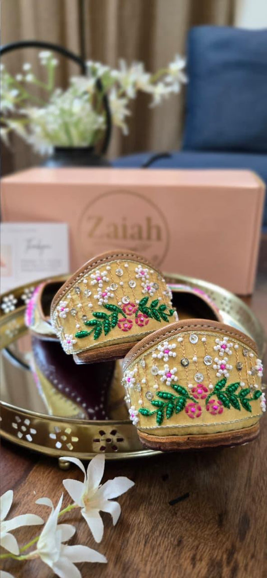 Decorative heart-shaped boxes with floral designs on a wooden surface, with 'Zaiah' branding in the background.